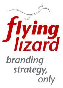The vertical configuration of the Flying Lizard Strategy Before Marketing logo presents a dynamic interplay of form and hierarchy. At the apex, a fluid, abstract representation of a lizard in flight is rendered in elegant grey strokes, suggesting movement and agility. Beneath this emblem, the company name is set in two tiers: “flying” and “lizard” appear in bold, italicised red lowercase, stacked for vertical emphasis and visual momentum. The tagline, “branding strategy, only” is distributed across three lines in a refined grey sans-serif typeface, maintaining legibility and reinforcing the brand’s strategic clarity. This format is optimised for portrait-oriented applications, preserving brand identity while ensuring visual coherence across varied media contexts.