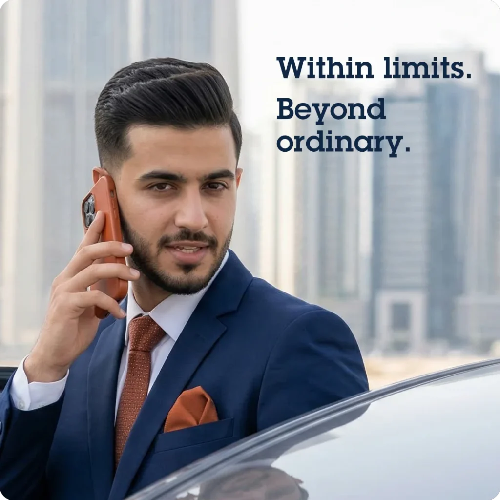 Professional conformity and modern mobile authority, shown through a young Middle Eastern real estate agent on a phone call just outside his car with a blurred cityscape background.