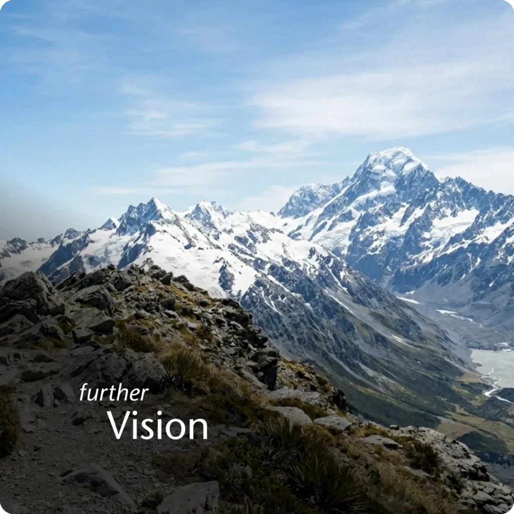 The realization that higher levels of success are attainable, shown through a POV shot from a mountain summit looking toward taller peaks.